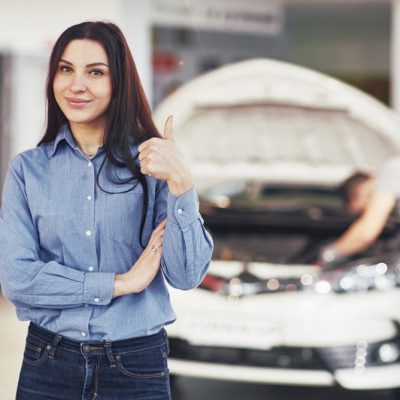 woman-approves-work-done-by-client-mechanic-works-hood-car